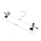 Set of metal hangers with clothes on a white background - textile care - vintage clothing - wardrobe hangers 